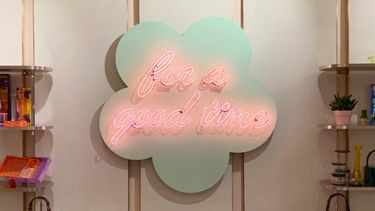 Neon signage in the shape of a cloud that reads for a good time